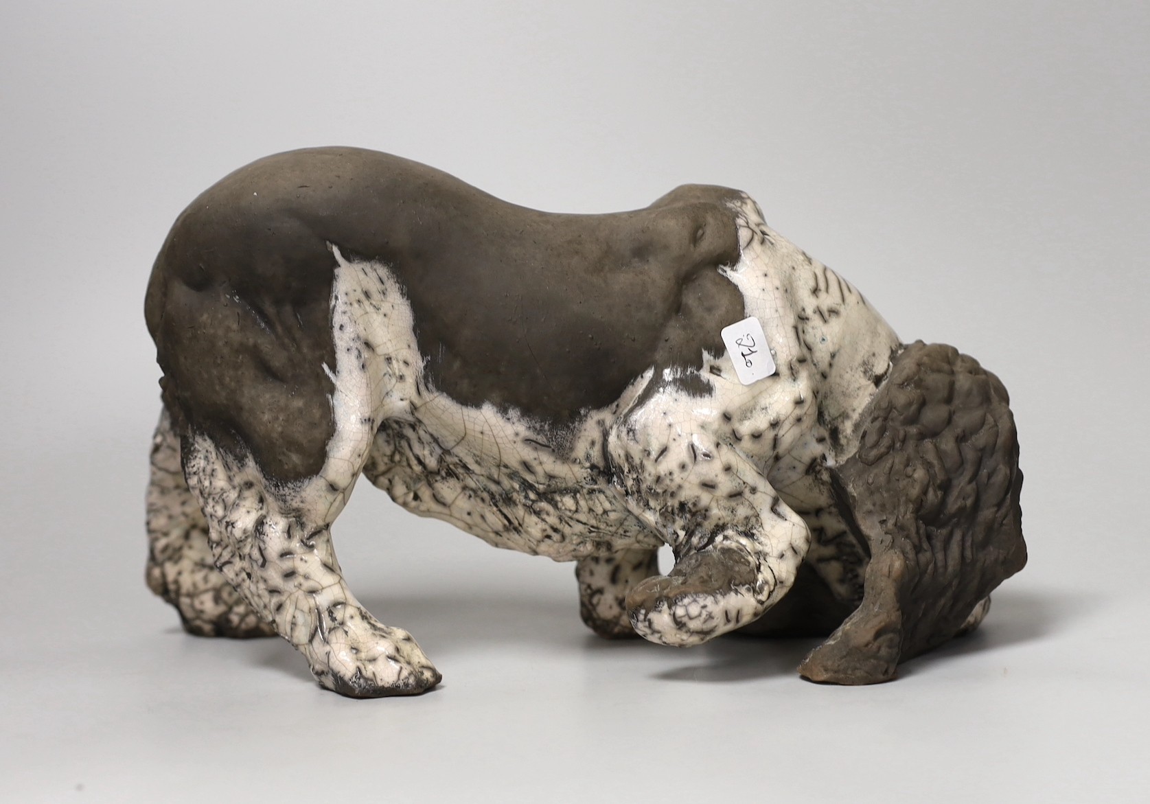 Keza Rudge (British 20th Century), a pottery model of a sniffing spaniel, signed. 29cm wide